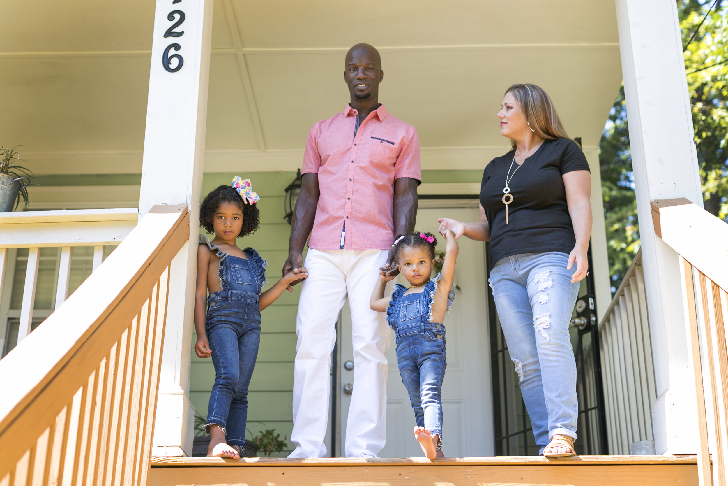 Michelle Witherspoon, Larry Witherspoon, and their two children stand on the porch of the home they purchased via a mortgage from FCS Community Finance. Photo by Becca Stanley.